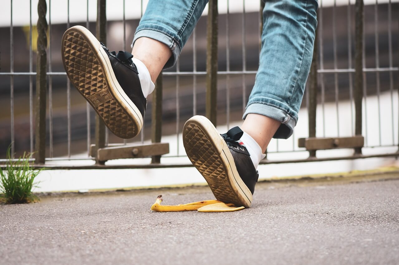 person slipping and falling on a banana peel