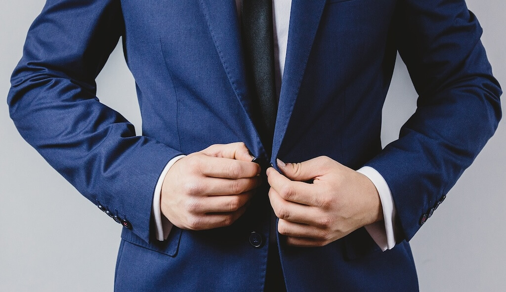 man putting up suit jacket