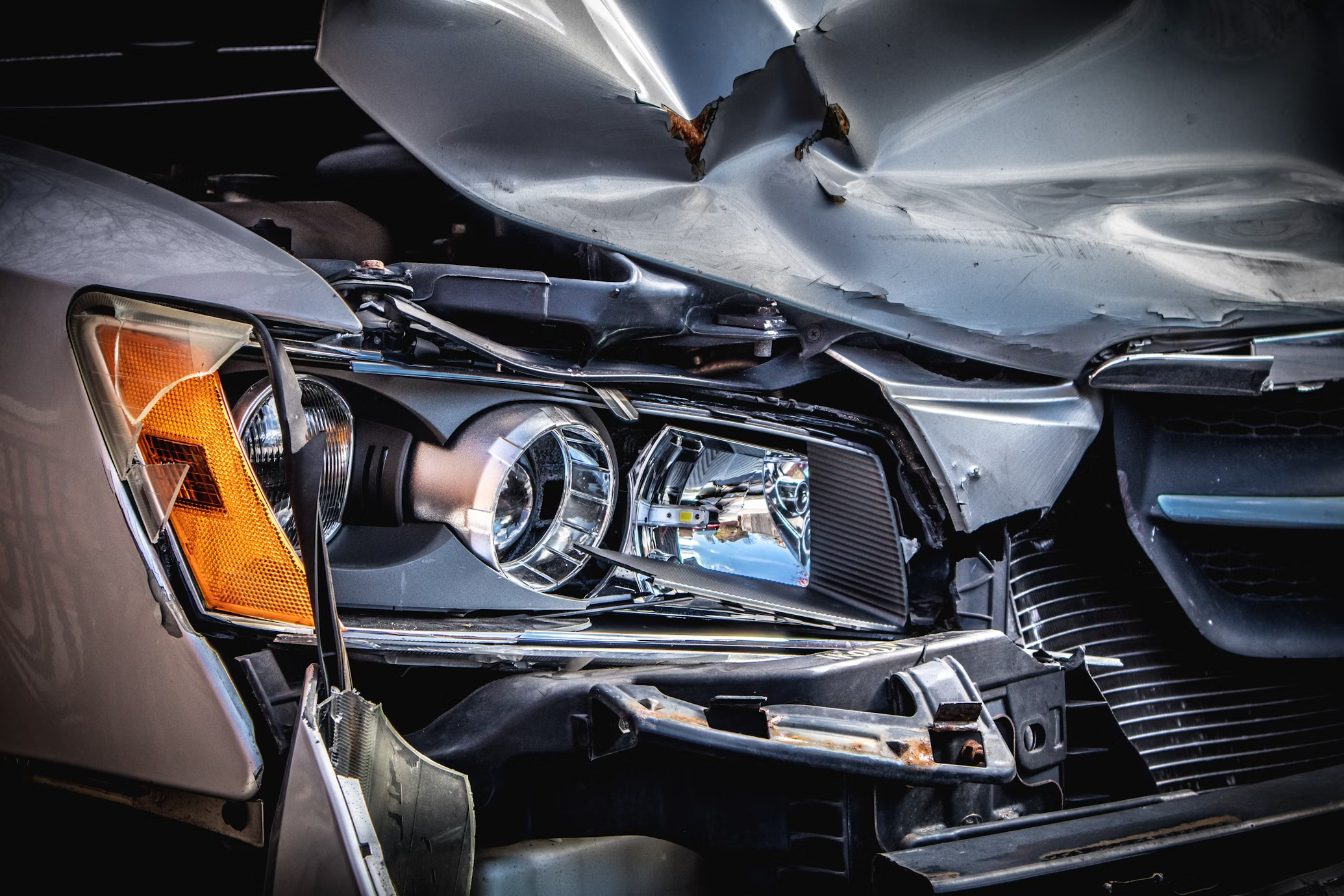 heavily damaged grey car after an accident