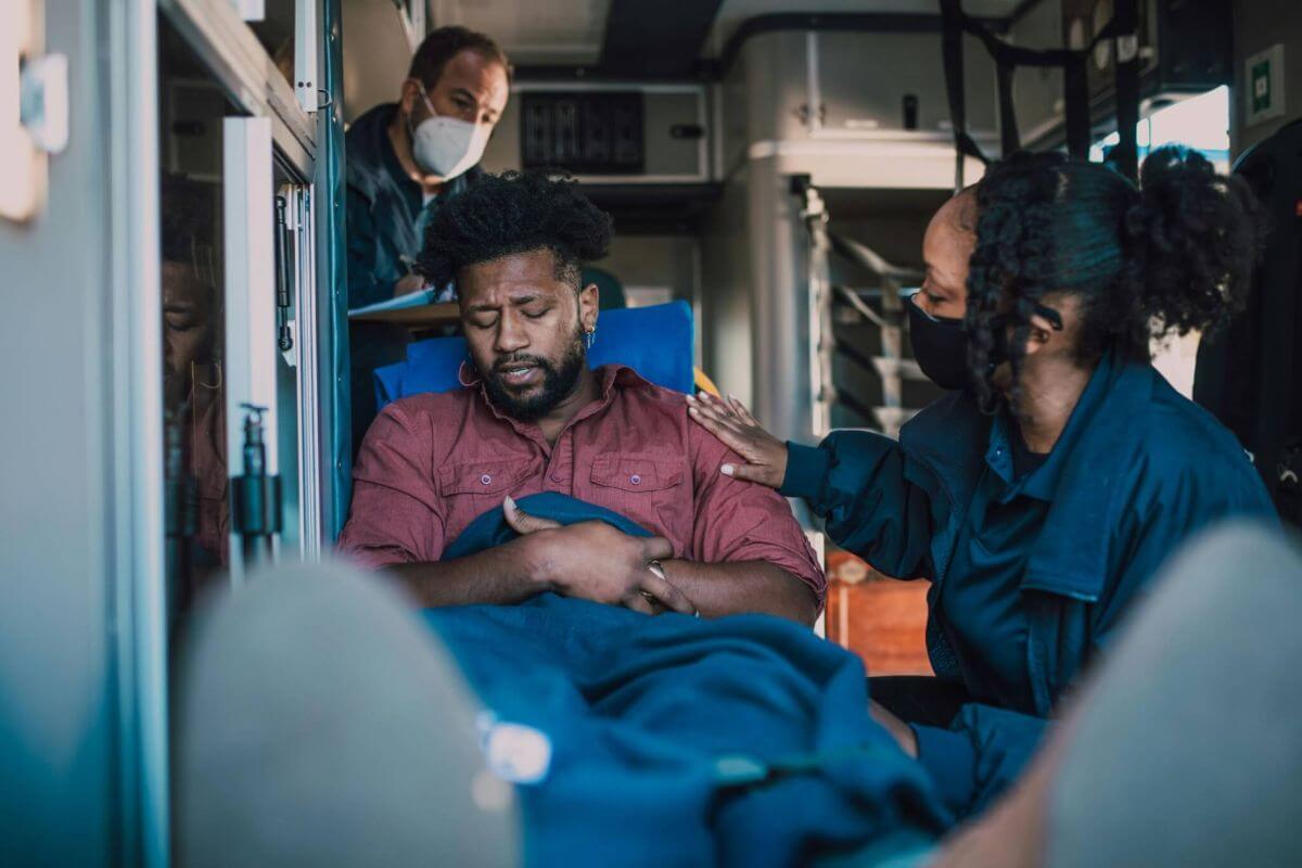 paramedics tending to injured person in back of ambulance