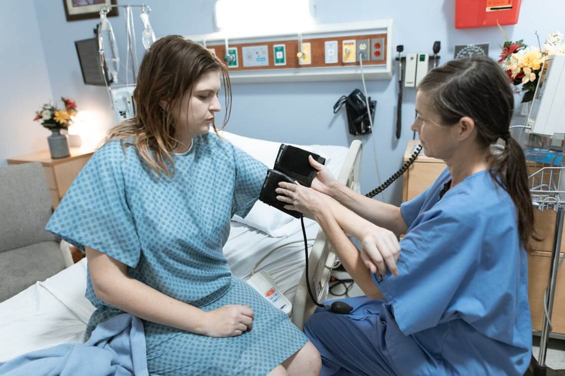 nurse measuring patient’s blood pressure nurse measuring patient’s blood pressure