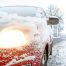 red sedan covered in snow