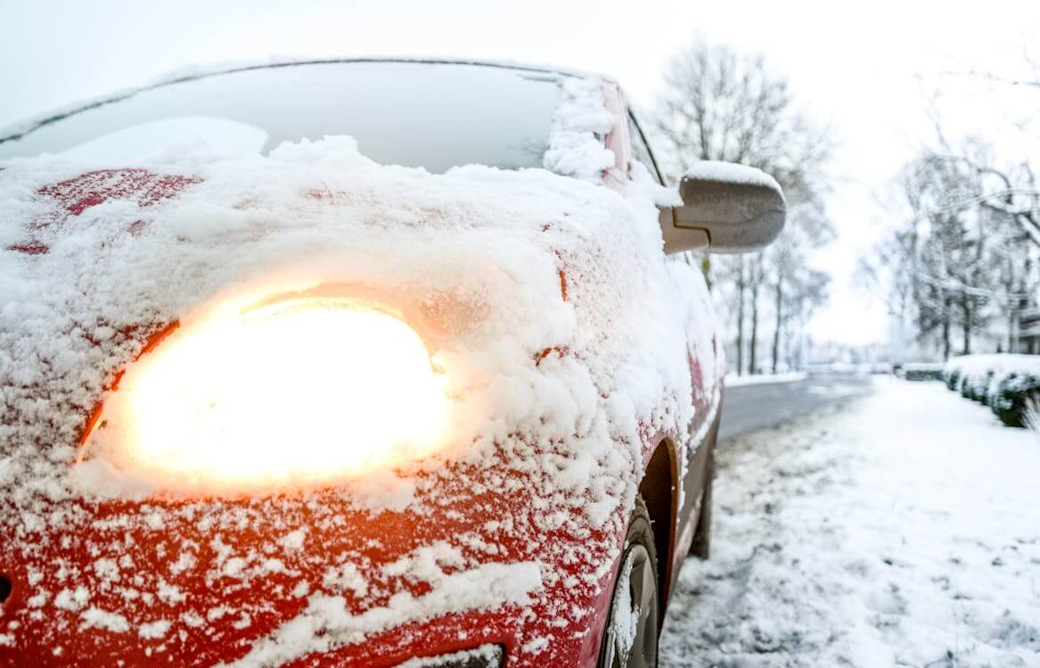 red sedan covered in snow red sedan covered in snow