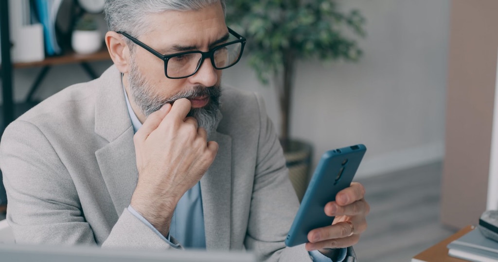 man reading from phone