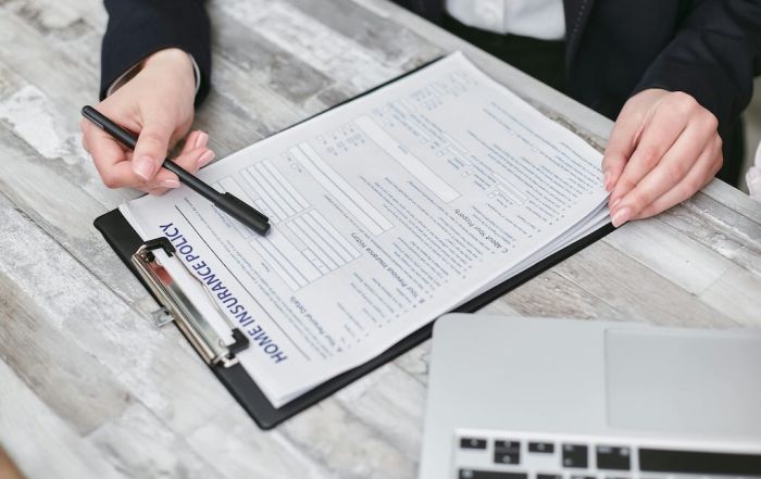 person reviewing home insurance policy paperwork