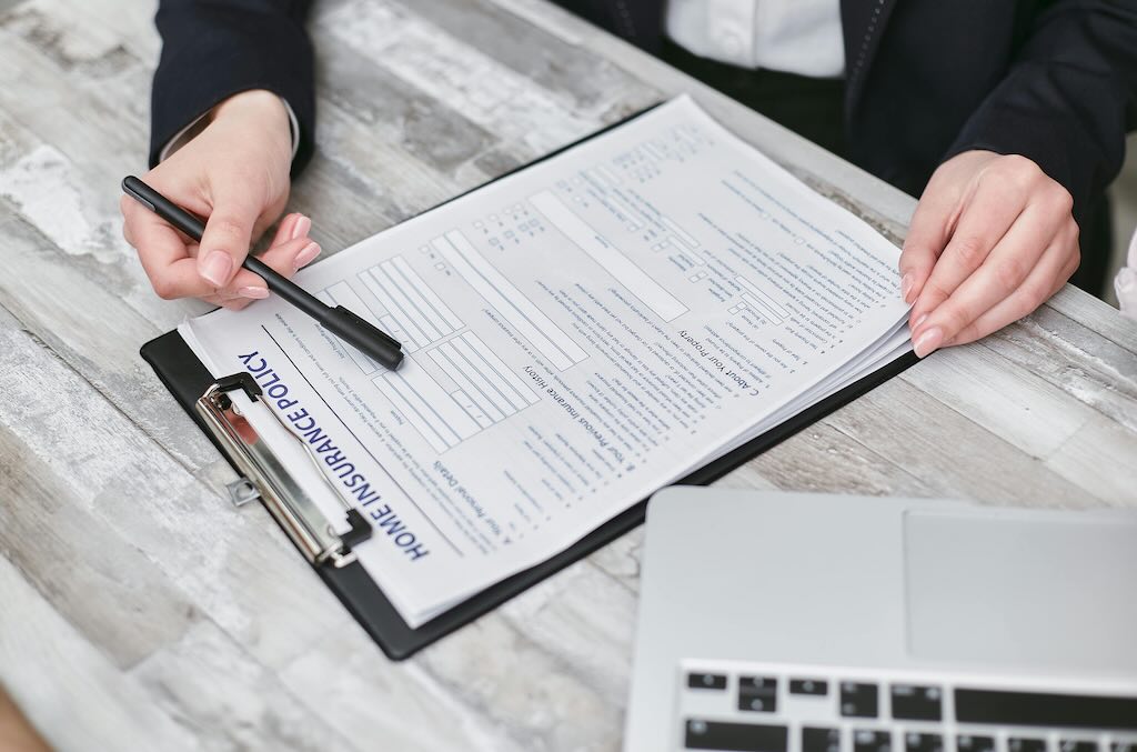 person reviewing home insurance policy paperwork