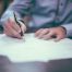 A person writing out paperwork