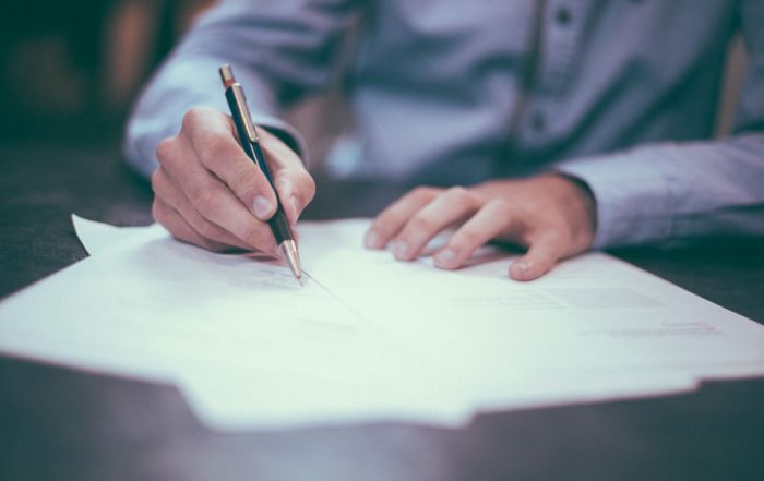 A person writing out paperwork