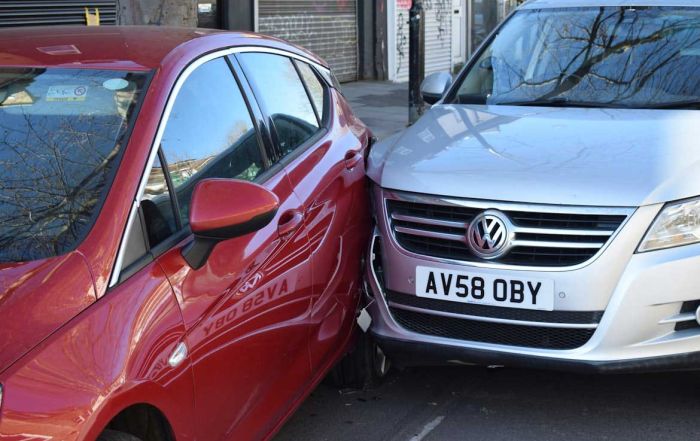 A picture of two cars crashed into each other
