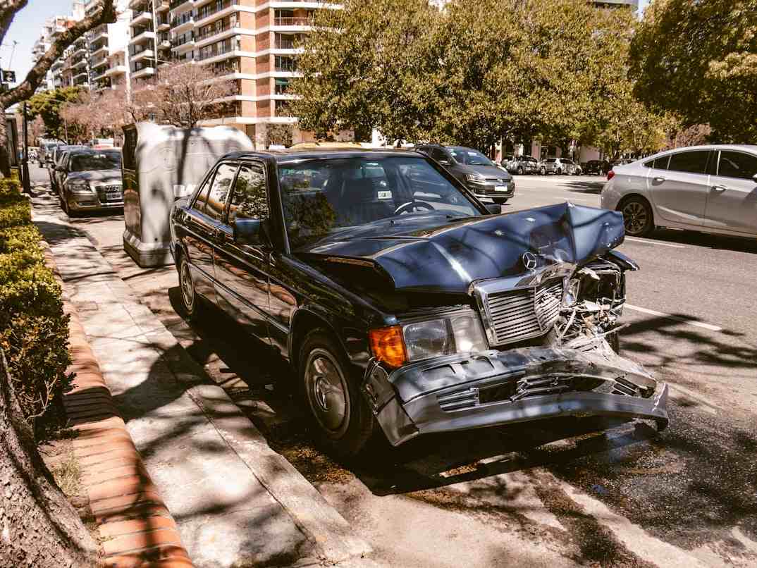 A car left heavily damaged on the side of the road