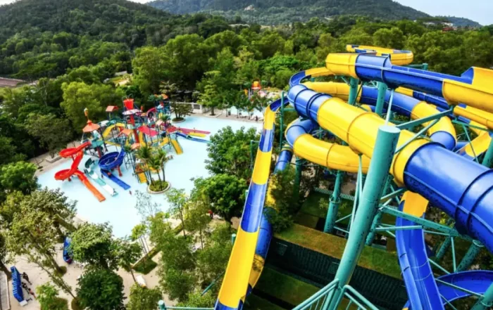 An aerial view of a waterpark with a large, swirling, yellow and blue slide