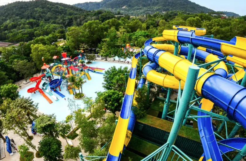 An aerial view of a waterpark with a large, swirling, yellow and blue slide