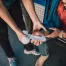 A person in a truck having their wrist wrapped by another person